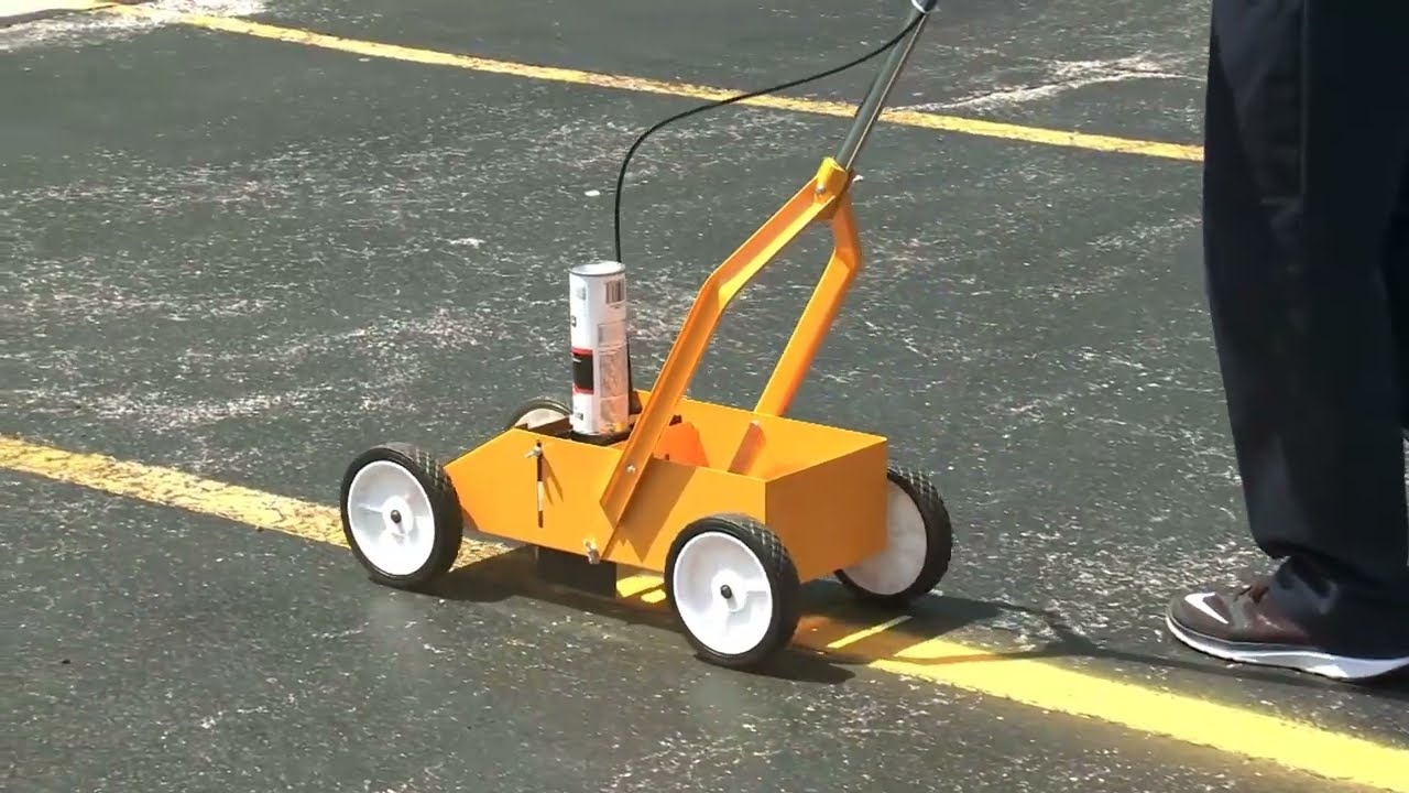 Line striping machine painting precision lines on pavement