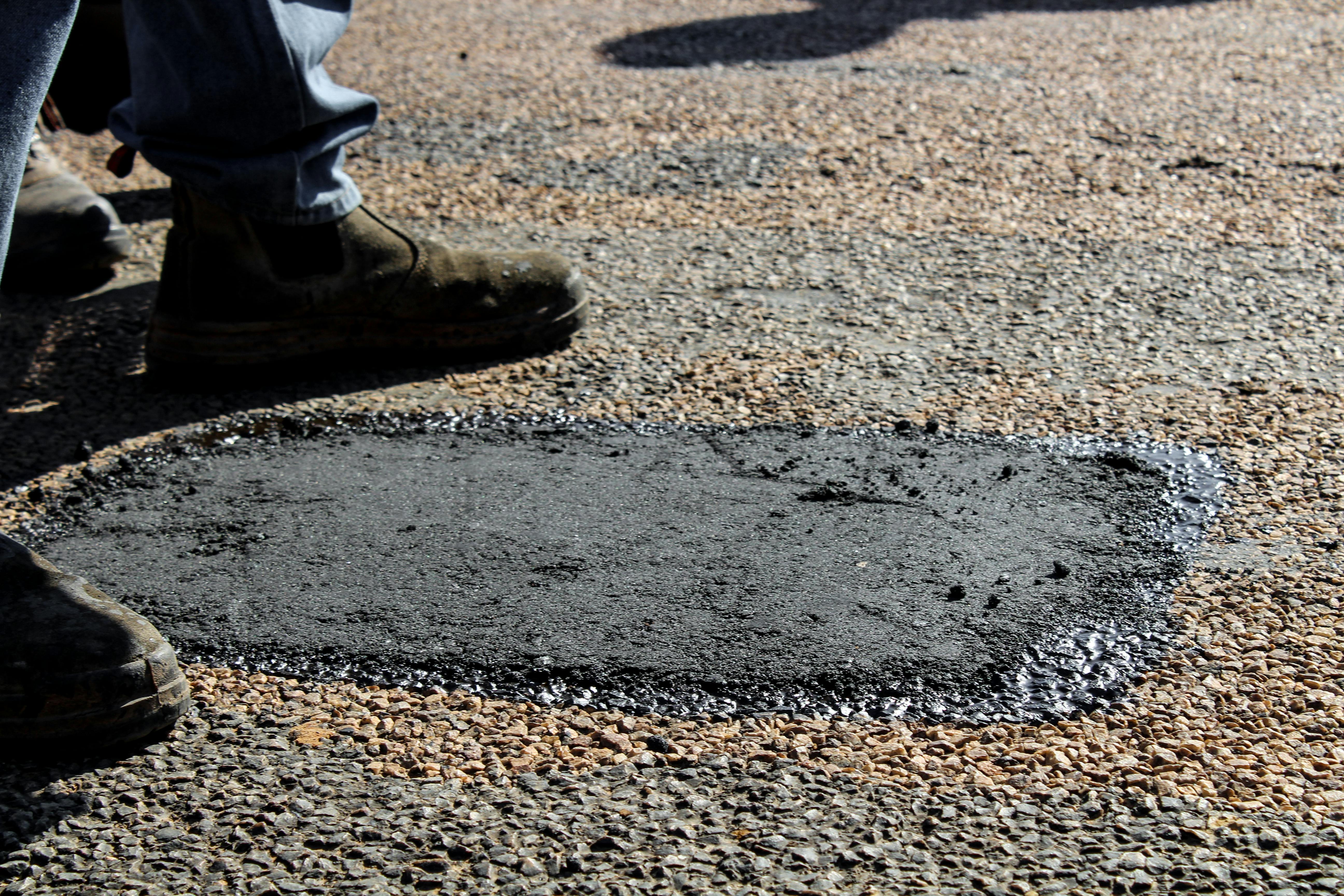 Before and after sealcoating showing dramatic improvement